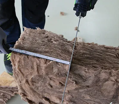 Se placer au niveau de la cote et couper l'isolation entre chevrons